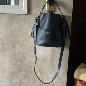 Coach 651 black drawstring bucket bag with side tassels.